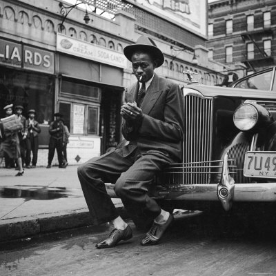 Baseball Player Satchel Paige, Looking Dapper, Lighting His Cigarette Outside Poolroom In Harlem by George Strock Pricing Limited Edition Print image
