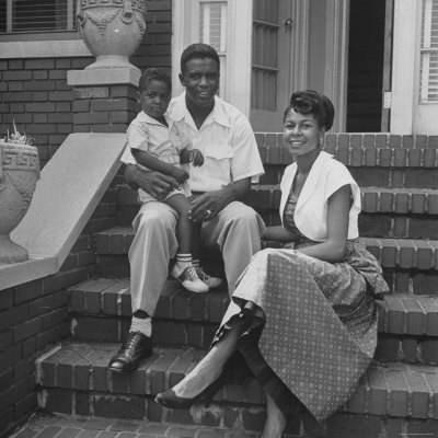 Baseball Star Jackie Robinson With Wife Rachel And Son Jackie Jr. Sitting On Front Steps Of Home by Nina Leen Pricing Limited Edition Print image