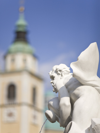 River God Statue On The Robba Fountain With The Cathedral Of St. Nicholas In The Background, Lublja by Lizzie Shepherd Pricing Limited Edition Print image