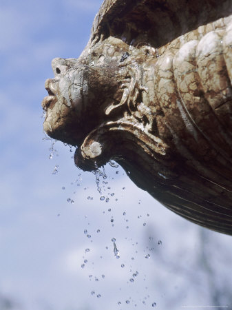 Figure On Fountain, Water Dripping From Mouth, Blue Sky Background Nyman's Gardens, Kent by Juliet Greene Pricing Limited Edition Print image