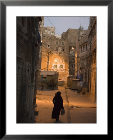Woman Walking In Old Town, Dusk, San'a, Yemen by Holger Leue Pricing Limited Edition Print image