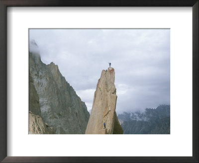 A Climber Stands Atop Tahir Tower, Karakoram Mountains, Pakistan by Jimmy Chin Pricing Limited Edition Print image