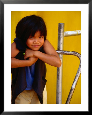 Portrait Of Lao Girl At Entrance To Wat St. Muang, Vientiane, Vientiane Prefecture, Laos by Martin Lladó Pricing Limited Edition Print image