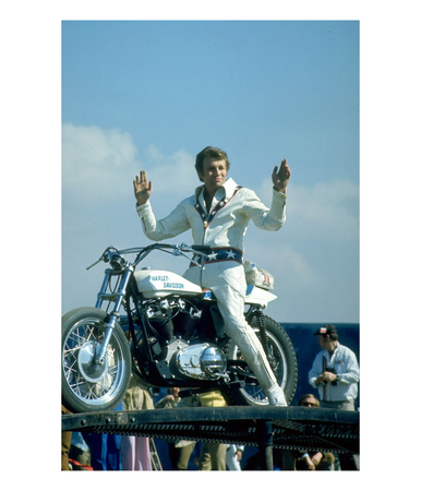 Motorcycle Daredevil Evel Knievel Poised On His Harley Davidson by Ralph Crane Pricing Limited Edition Print image