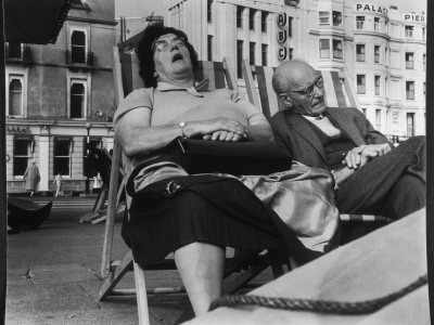 Holidaymakers Asleep In Deckchairs On The Sea Front At Brighton, West Sussex by Henry Grant Pricing Limited Edition Print image