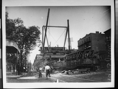 Boys And Well-Dressed Men Standing Near The Construction Site For An Elevated Train Bridge by Wallace G. Levison Pricing Limited Edition Print image