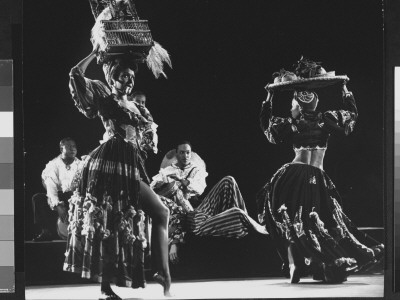 Dancing Barefoot With Cigar In Mouth And Birdcage Balanced On Head During Tropical Revue by Gjon Mili Pricing Limited Edition Print image