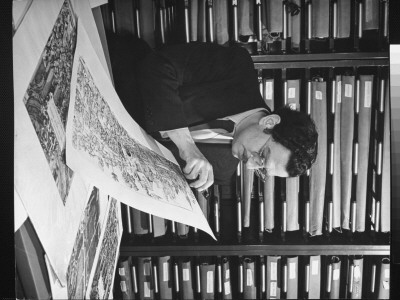 Sculptor Louis Slobatkin Doing Research In Picture Collection Of New York Public Library by Alfred Eisenstaedt Pricing Limited Edition Print image