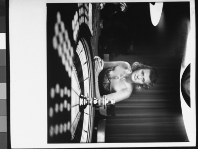 Anxiously Eyeing The Wheel At Roulette Table In Gambling Salon At The Caribe Hilton Hotel by Gordon Parks Pricing Limited Edition Print image
