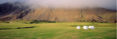 Hay Bales In A Field In Front Of A Mountain by Snaevarr Gudmundsson Pricing Limited Edition Print image