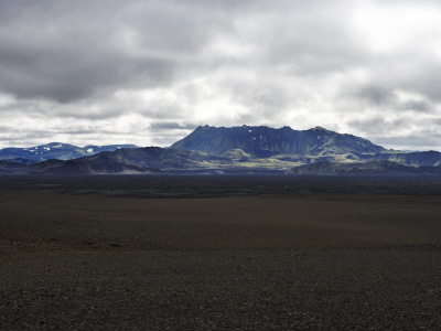A Plateau In The Highlands Of Iceland, Mountains In Distance by Atli Mar Pricing Limited Edition Print image