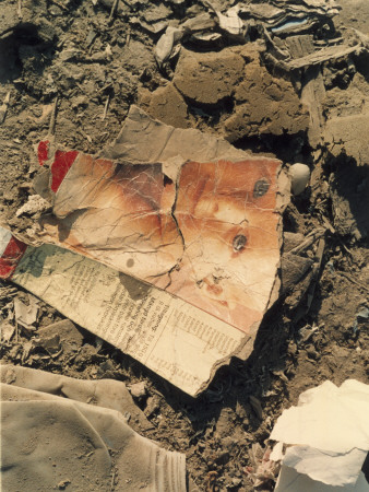 A Creased Picture Of A Child's Face Lying On The Ground by Eva Wernlid Pricing Limited Edition Print image