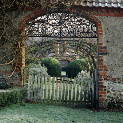 View Looking Into The Old Cob-Walled Vegetable Garden At Heale House, Wiltshire by Clive Nichols Pricing Limited Edition Print image