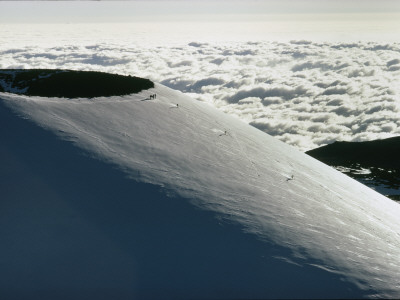 Skiers Schuss Down The Broad Expanse Of Mauna Kea In Hawaii by Robert Madden Pricing Limited Edition Print image