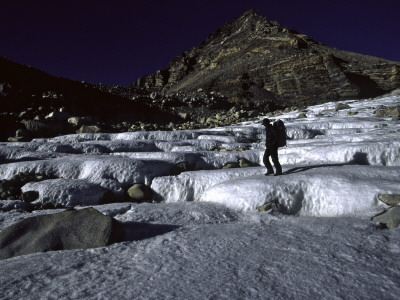 A Climber Crossing A Frozen River, Tibet by Michael Brown Pricing Limited Edition Print image