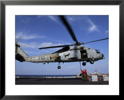 Two Aviation Ordnancemen Connect Transport Cables To A Sh-60B Helicopter by Stocktrek Images Pricing Limited Edition Print image