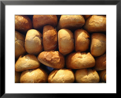 Wall Of Fresh-Baked Loaves Of Bread Awaits Buyers At The Bakery by Stephen St. John Pricing Limited Edition Print image
