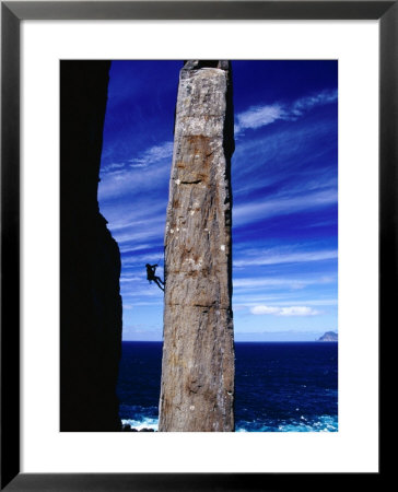 Rock-Climber Ascending The Totem Pole Rock Stack On The Tasman Peninsula, Australia by Grant Dixon Pricing Limited Edition Print image