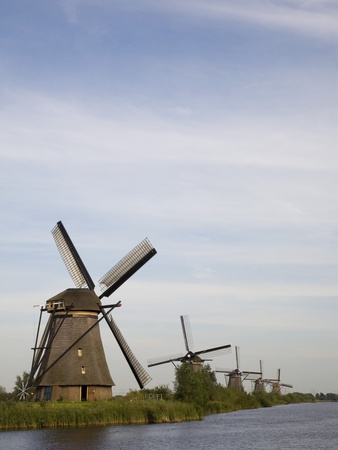 Row Of Windmills By River by Tom Paiva Pricing Limited Edition Print image