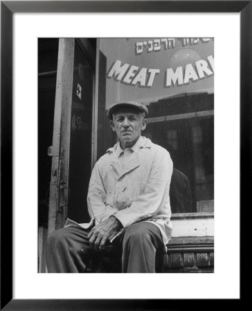 Butcher Taking A Break, Sitting In Front Of Meat Market by Ed Clark Pricing Limited Edition Print image