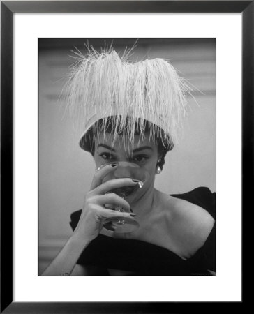 Woman Modeling White Satin Hat, With White Glycerin Feathers To Flatter Low Draped Neckline by Nina Leen Pricing Limited Edition Print image