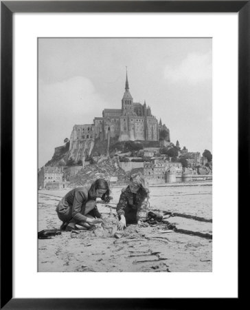 American Travelers Building A Sand Replica Of France's Medieval Abbey At Mont Saint Michel by Yale Joel Pricing Limited Edition Print image