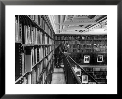 Man Reading Book Among Shelves On Balcony In New York Public Library by Alfred Eisenstaedt Pricing Limited Edition Print image