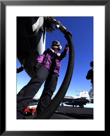 Airman Fuels An Aircraft Prior To Launch Aboard Aircraft Carrier Uss John C Stennis by Stocktrek Images Pricing Limited Edition Print image