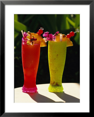 Two Tall Cold Tropical Drinks Garnished With Fruit And Flowers by Richard Nowitz Pricing Limited Edition Print image
