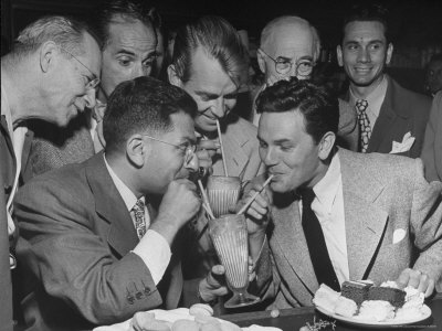 Sidney Skolsky Sharing A Float With John Garfield At The Drugstore Party by Peter Stackpole Pricing Limited Edition Print image