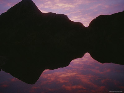 Mountain Silhouettes Reflected In Moresby Lake At Twilight by Stephen Sharnoff Pricing Limited Edition Print image