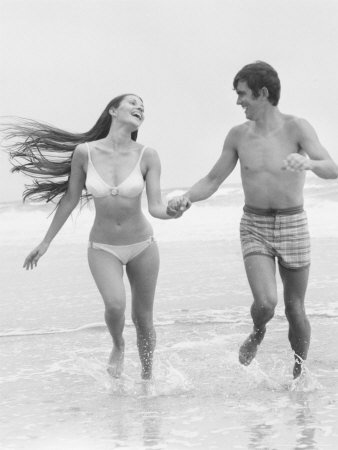Couple Running Along Shore by Ewing Galloway Pricing Limited Edition Print image
