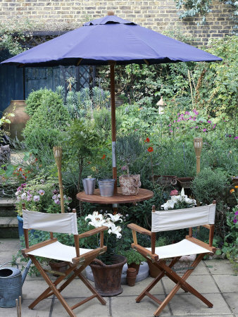 Wooden Table & Chairs With Parasol On Patio, Pots With Lilium, Lavender & Viola by Linda Burgess Pricing Limited Edition Print image