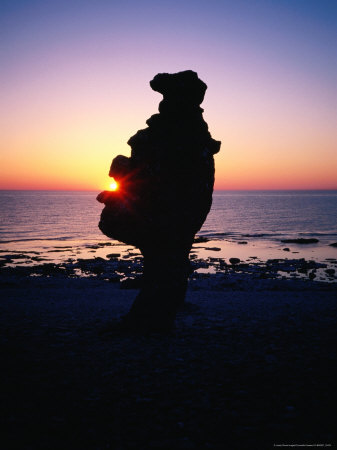 Raukar Limestone Formations, Silhouetted Against A Perfect Sunset At Langhammarshammaren, Sweden by Cornwallis Graeme Pricing Limited Edition Print image