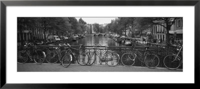Bicycle Leaning Against A Metal Railing On A Bridge, Amsterdam, Netherlands by Panoramic Images Pricing Limited Edition Print image