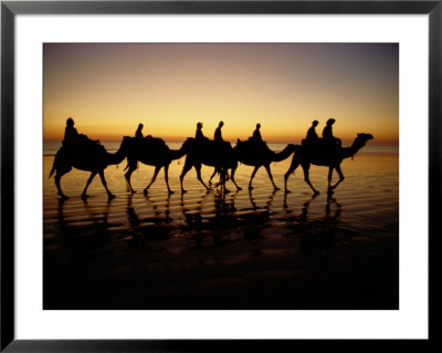 Silhouettes Of Tourists Riding Camels On A Beach by Paul Chesley Pricing Limited Edition Print image