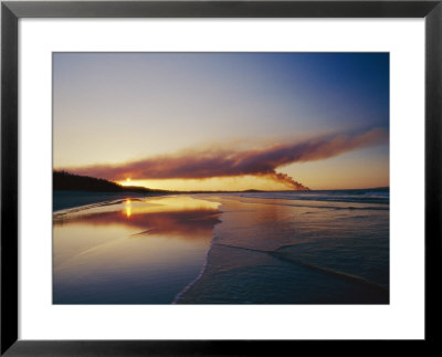 Smoke From A Brushfire Forms A Large Cloud Over A Shoreline Bathed In Low Sunlight by Jason Edwards Pricing Limited Edition Print image