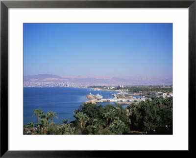 View Over Red Sea Resort Marina And Beach Hotels Towards Israeli Town Of Eilat, Aqaba, Jordan by Christopher Rennie Pricing Limited Edition Print image