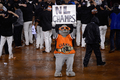 San Francisco, Ca - Oct. 22: Giants V Cardinals - Lou Seal Holds Up A Sign Reading 'Nl Champs' by Thearon W. Henderson Pricing Limited Edition Print image