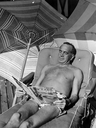 Singer Al Jolson Reading The New Yorker Magazine In Lounge Chair While Enjoying The Sun On The Beac by Alfred Eisenstaedt Pricing Limited Edition Print image