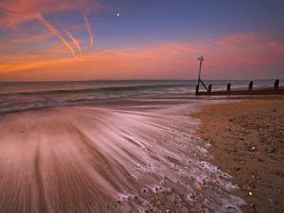 Moon Still Glows Above The Surging Tide At Sunrise On Hayling Island, Hampshire, England, Uk by Adam Burton Pricing Limited Edition Print image