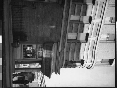 Writer Damon Runyon Standing Outside Restaurant On 20Th Century Fox Lot Chatting With Studio Guard by Gjon Mili Pricing Limited Edition Print image