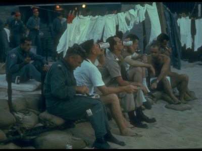 Us Pilots Relaxing Among Laundry Lines During Weekly Sunday Steak And Beer Cookout, Vietnam War by Larry Burrows Pricing Limited Edition Print image