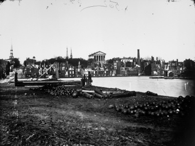 Ruins Of City: Soldier Stands Amid Idle Arsenal Of Cannons And Ammo, At End Of Civil War by Andrew Joseph Russell Pricing Limited Edition Print image