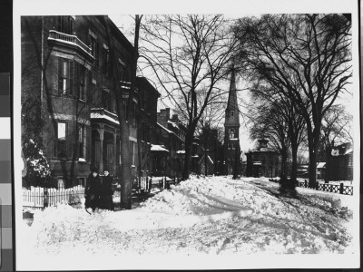 Next To A Sled After A Heavy Snowstorm With A Church And Victorian-Style Homes by Wallace G. Levison Pricing Limited Edition Print image