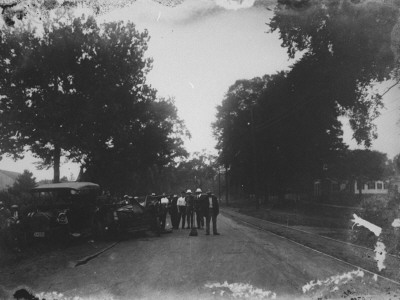 A Group Of Men Standing Around The Wreckage Of A Two-Car Collision On A Country Road by Wallace G. Levison Pricing Limited Edition Print image