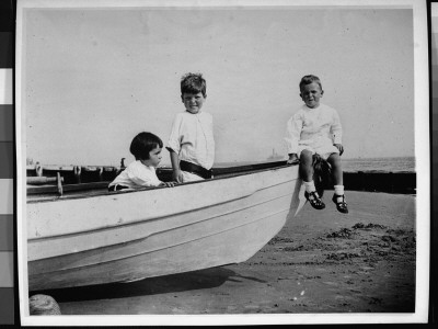 Chester Lord And Two Young Friends Sitting In A Boat On A Beach by Wallace G. Levison Pricing Limited Edition Print image