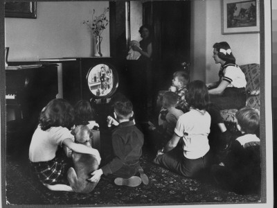 Grade School Kids Sitting Around Tv Set In Living Room At Home by Francis Miller Pricing Limited Edition Print image