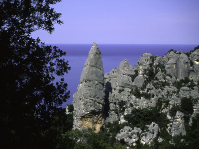 Climber Atop A Limestone Rock Face, Sardenia Italy by Michael Brown Pricing Limited Edition Print image