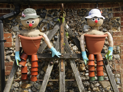 Comical Flowerpot Men Feature In A Country Garden, Norfolk, Uk by Gary Smith Pricing Limited Edition Print image